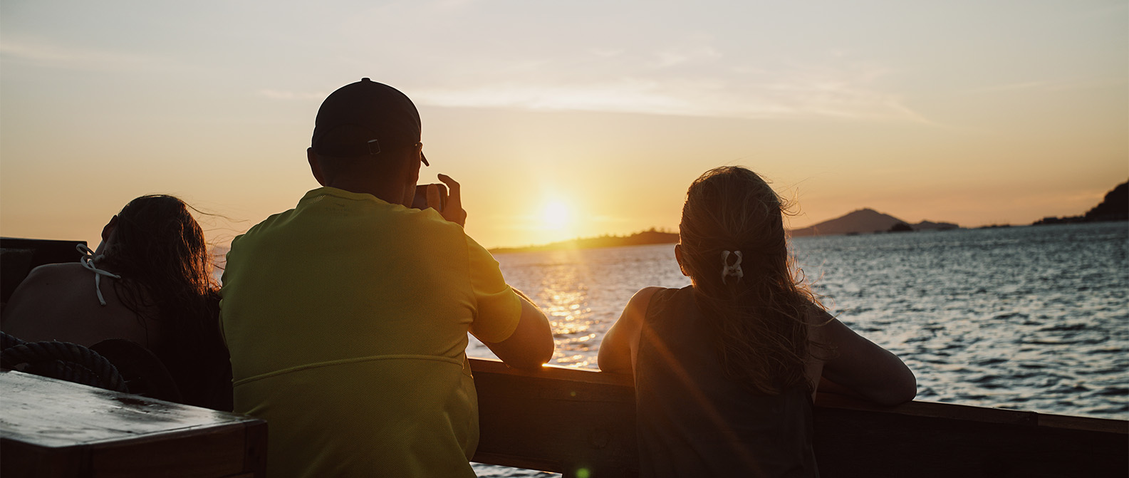 Tourists enjoying sunrise view on a Komodo liveaboard tour.